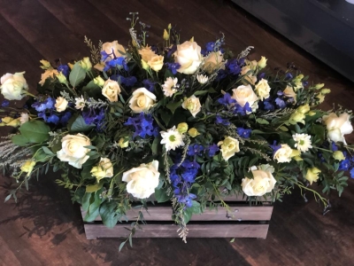 Casket spray in blue and whites